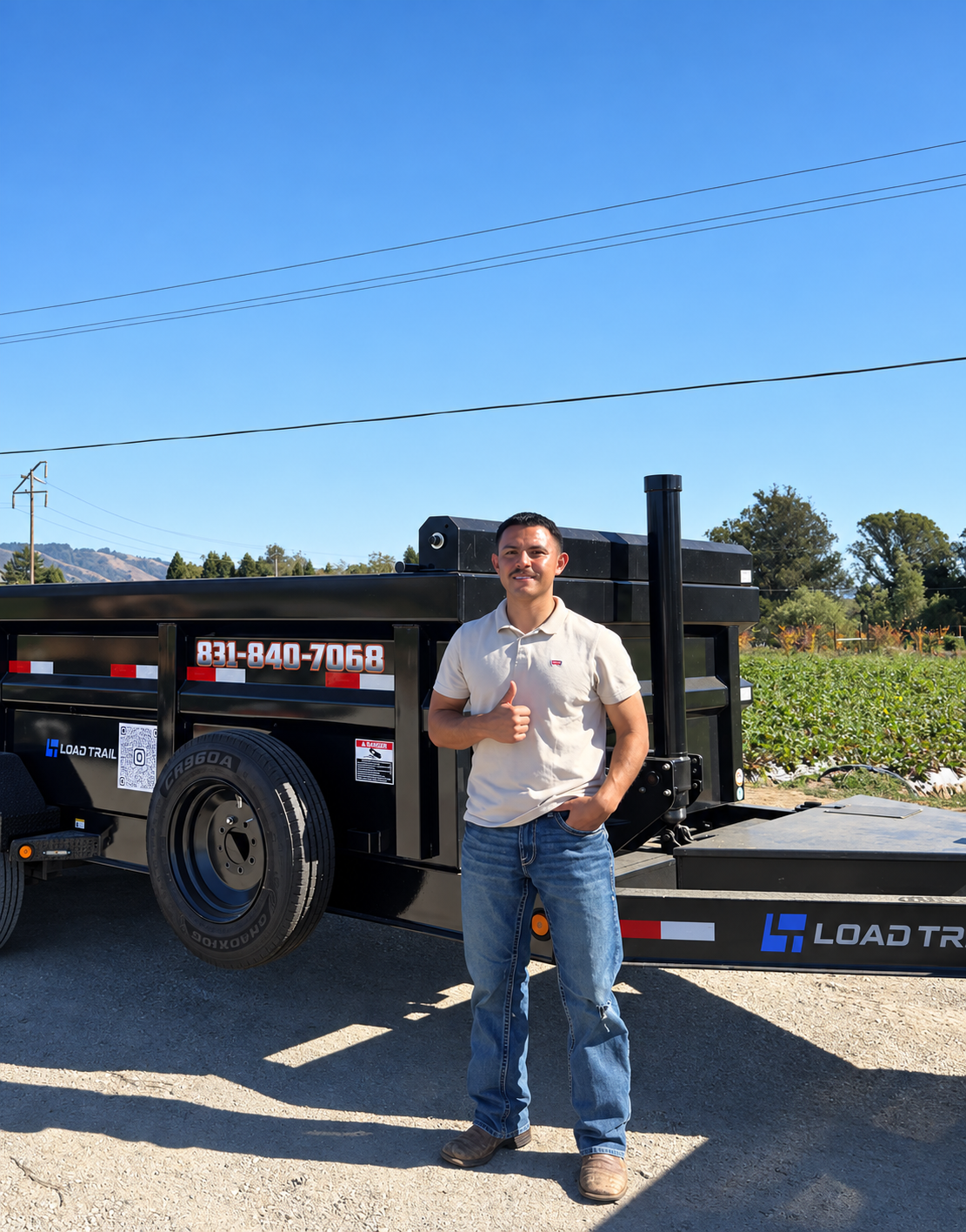 Oscar giving a thumbs-up beside the JT Junk Removal trailer